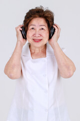 Smart senior woman wondering music rhythms while listening doubted song from modern earphone