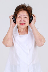 Fototapeta premium Smart senior woman wondering music rhythms while listening doubted song from modern earphone