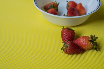 Strawberries on yellow background