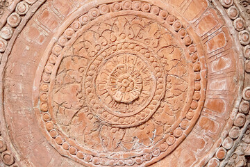 Fototapeta na wymiar Engraving on stone wall background with flower circle patterns