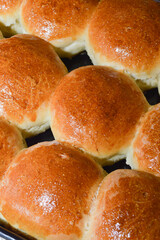 The process of making fresh round-shaped yeast buns.