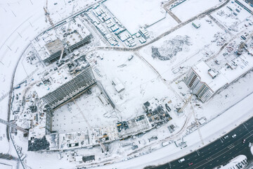 winter aerial view of construction site at residential area. new apartment buildings under construction.