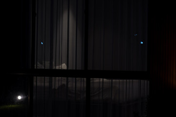 Looking from outside to bedroom at night