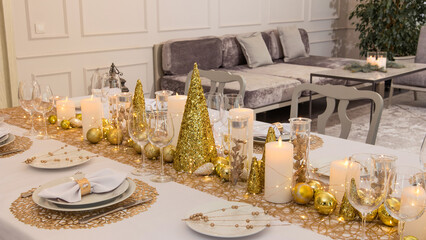 Beautiful table setting with Christmas decorations. Gold colors
