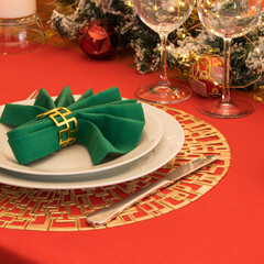 Beautiful table setting with Christmas decorations. Red colors