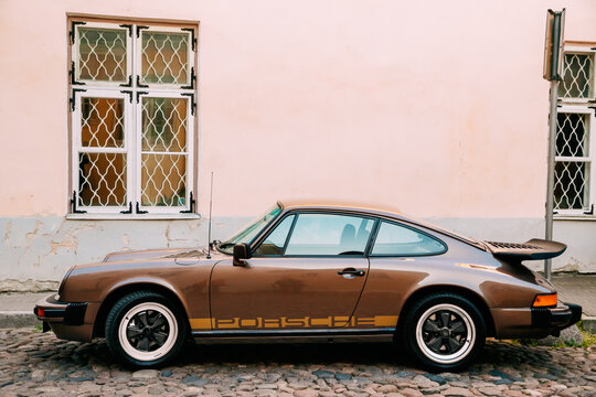 Tallinn, Estonia - July 1, 2019: Front View Of Porsche 930 Car Parked In Old Narrow Street. It is a sports car manufactured by German automobile manufacturer Porsche Between 1975 And 1989.