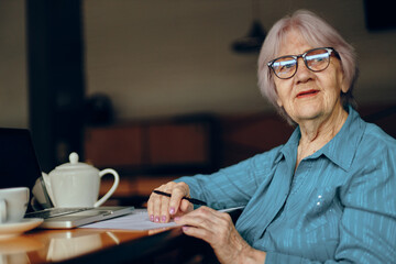 Beautiful mature senior woman working in front of laptop monitor sitting Lifestyle unaltered