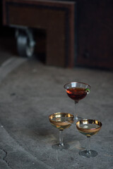 three cocktails stacked in pyramid on concrete floor
