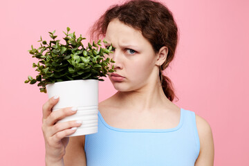 pretty woman potted flower posing plant pink background unaltered