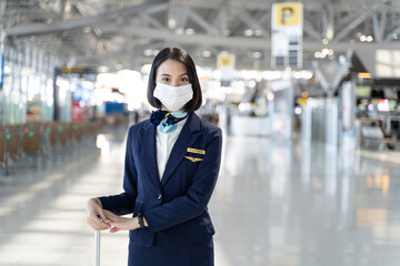 Portrait of Caucasian flight attendant standing in airport terminal.