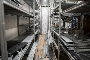 Assembly of a warehouse in a clothing store with stacked iron shelves