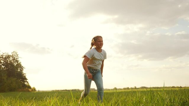 little girl with a teddy bear run in the park on the grass. happy family kid dream concept. little girl run in the park holding a teddy bear. happy fun childhood dream. kid walk in the park
