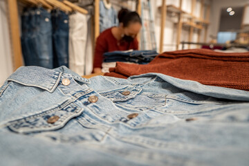 Woman folding clothes in a store in times of covid