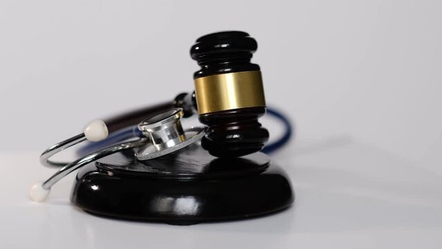 Stethoscope and judgement hammer. Gavel and stethoscope. medical jurisprudence. legal definition of medical malpractice. attorney. common errors doctors, nurses and hospitals make.