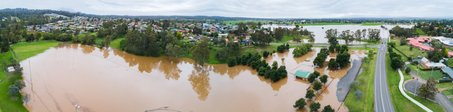 Panorama of brown floodwaters on overcast day