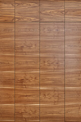 Wooden wall panel made of walnut veneered MDF with hidden doors as background for design and decor