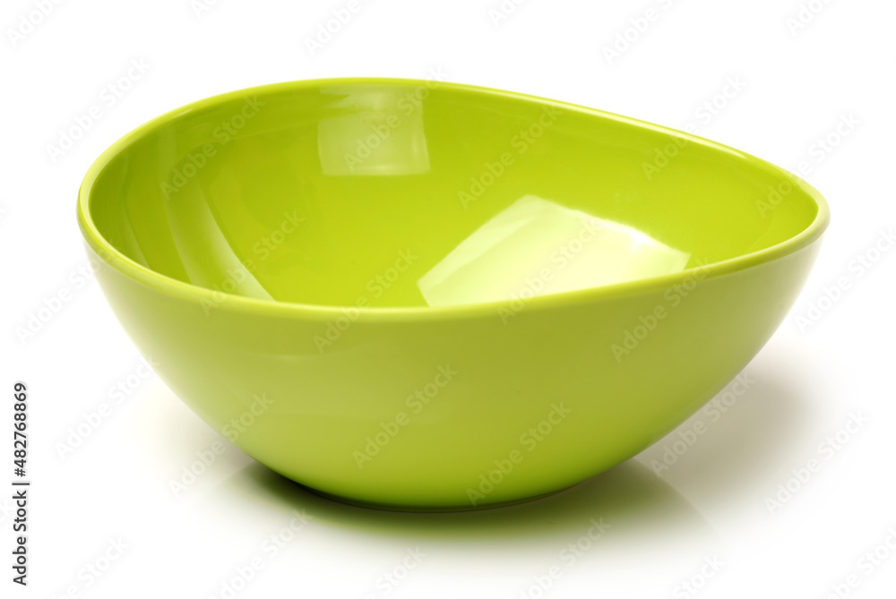 Wall mural Bright green plastic empty bowl on a white background 