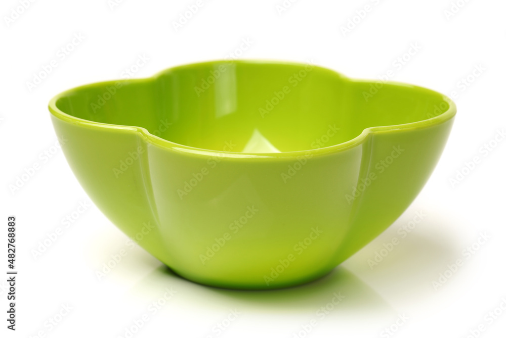 Poster  Bright green plastic empty bowl on a white background