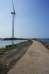 seaside walkway and wind power plant