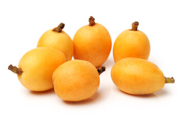 Close up view of some loquat fruit isolated on a white background