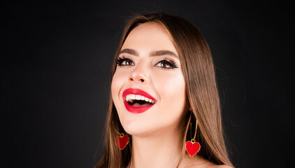 Beautiful happy girl. Young smiling woman with make up in black studio. Fashion portrait of female model with red lips.