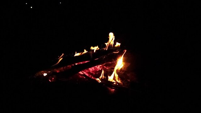 Campfire crackling at night in slow motion.