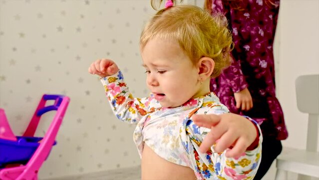 The child sits on the potty in the toilet. Selective focus.