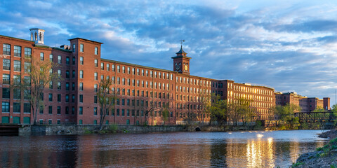 Sunset in Nashua. Historic cotton mill building with clock tower in Nashua Old Industrial Park....