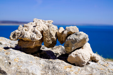 Zen outdoors stacked rocks balanced stones stack pyramid bridge with sea coast background water beach ocean horizon