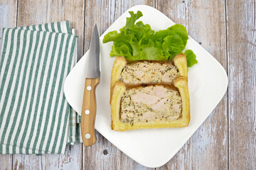 slice of chicken mustard pâté en croute on a plate