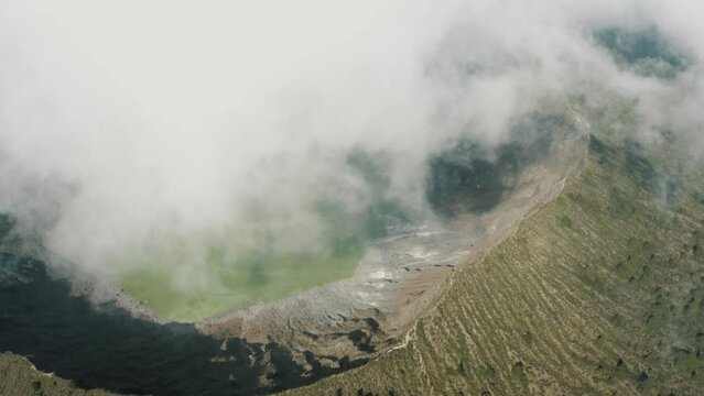 Misty Landscape At El Chichonal Volcano With Green Sulfuric Lake In Crater - aerial drone shot