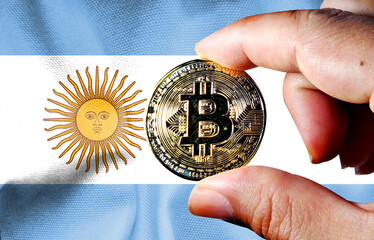  Hold a physical version of Bitcoin (the new virtual currency) and the flag of Argentina....