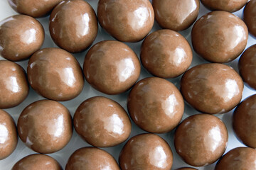 Top view of milk chocolate covered hazelnuts - Powered by Adobe