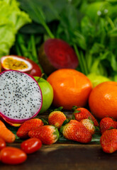 Top view close up shot of various kinds of healthy tasty nutritious fresh raw natural organic agriculture vegan vegetables and fruits ingredient diet placed on old colorful wooden table background