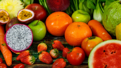 Top view close up shot of various kinds of healthy tasty nutritious fresh raw natural organic agriculture vegan vegetables and fruits ingredient diet placed on old colorful wooden table background