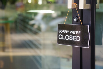 "sorry we're closed" label in front of glass door at the coffee shop to notice customer service