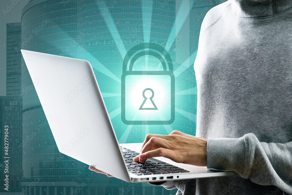 Aufkleber Close up of hacker hand using laptop with glowing padlock on coding city background. Digital safety, security, antivirus and protection concept.