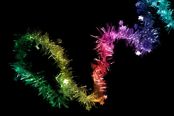Colorful tinsel on black