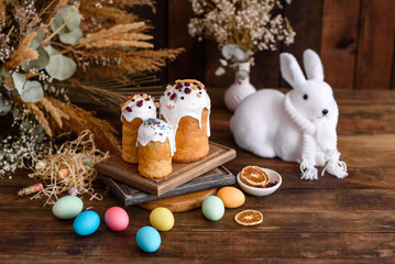 Easter eggs with cake on a brown wooden table