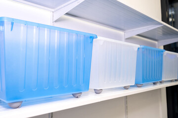 Organization of the space at home, storage of things, a lot of plastic boxes, new container boxes for convenient storage of things.