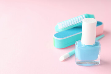 Concept of nail care with manicure accessories on pink background