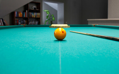 billiard balls and cue on the pool table
