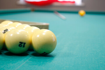 billiard balls and cue on the pool table