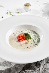 Fish creamy soup in norwegian style. Finnish fish soup with tomato, dill and creamy. Scandinavian food - salmon creamy soup. Seafood chowder with vegetables and fish. Norwegian cuisine.