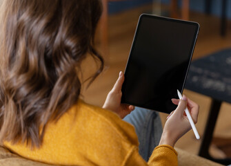 Girl working at home with a tablet during quarantine