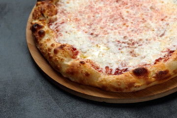 Pizza Margherita on dark stone background, top view. Flyer and poster for Restaurants or pizzerias, template with delicious taste margarita pizza, mozzarella cheese