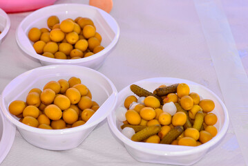 plastic plates with olives and pickles