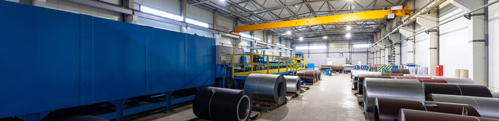 Panoramic photo of steel roofing forming machine. Industrial machine for metal sheet roof coils...