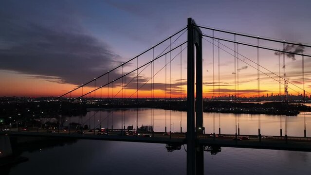 later dusk flying clockwise around Bronx Whitestone Bridge with NYC in bkrd