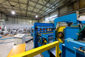 Production line of metal tile for roof. Steel forming machine in metalwork factory workshop